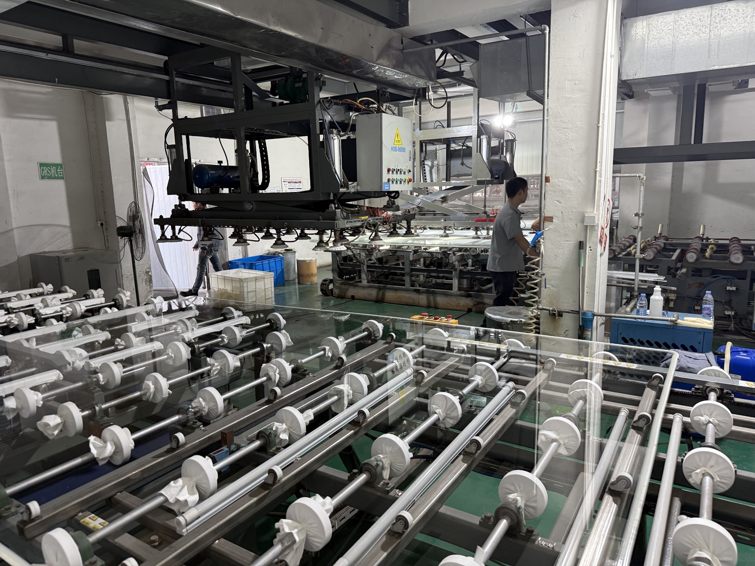 Actual acrylic casting line with steel roller beds and overhead equipment