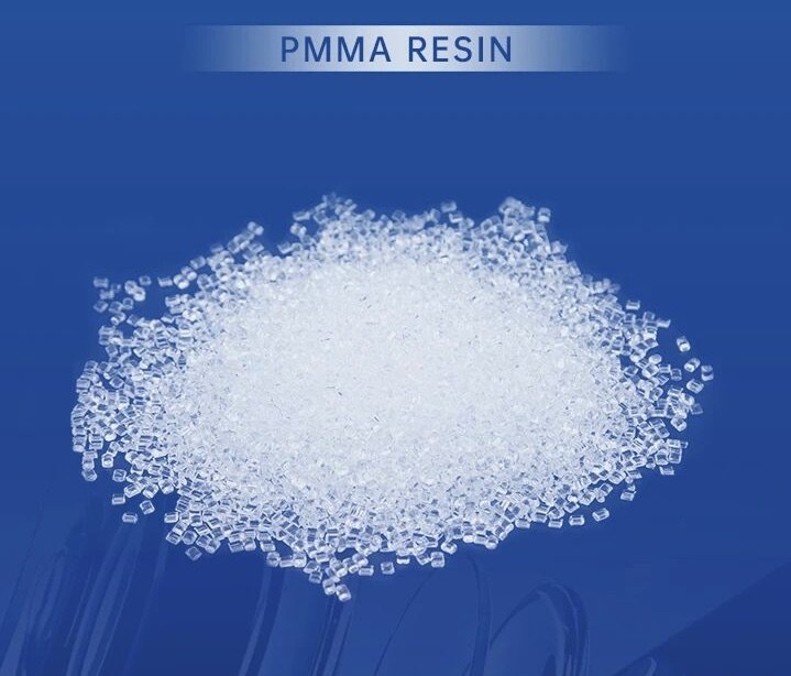 Transparent PMMA resin pellets on a blue background